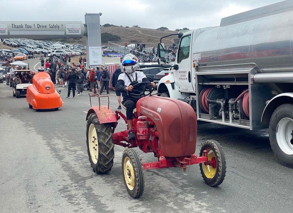 Matt Campbell does a demo lap in a Porsche tractor at Rennsport Reunion 7 Laguna Seca 2023